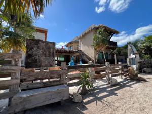 a building on the beach with a wooden fence at Flamingo Blue - Casa Boutique - Adults Only in El Cuyo