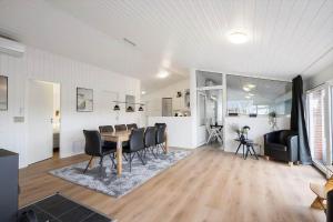 a dining room and living room with a table and chairs at 354-Hvide-Sande-Fyrmarken-24 in Hvide Sande