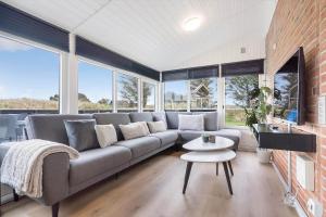 a living room with a couch and a table at 354-Hvide-Sande-Fyrmarken-24 in Hvide Sande