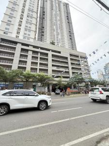 a white car parked in front of a large building at LM50L2 horizon101 cebu in Cebu City