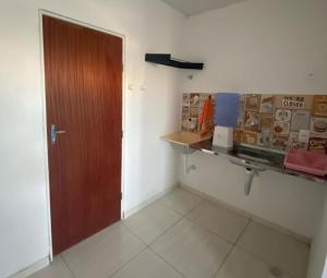 a room with a door and a counter in a room at ML Integra Mix kitnets in Maceió
