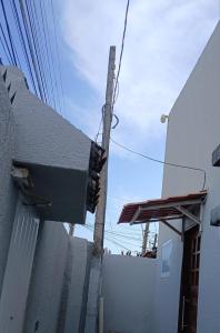 a traffic light on a pole next to a building at ML Integra Mix kitnets in Maceió