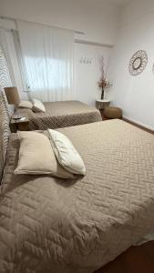 a bedroom with two beds with pillows on it at Apartamento Flowers in Buenos Aires