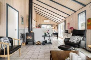 a living room with a fireplace and a table at 604-Hvide-Sande-Bjerregardsvej-193 in Bjerregård