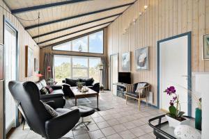a living room with a couch and a table at 604-Hvide-Sande-Bjerregardsvej-193 in Bjerregård