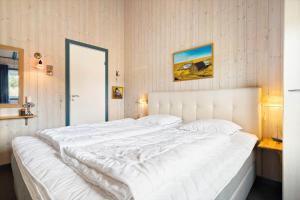 a large white bed in a bedroom with at 604-Hvide-Sande-Bjerregardsvej-193 in Bjerregård