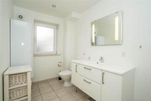a white bathroom with a toilet and a sink at 770-Hvide-Sande-Norregade-4-B in Hvide Sande +19 photos