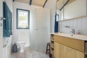 a bathroom with a toilet and a sink at 604-Hvide-Sande-Bjerregardsvej-193 in Bjerregård +38 photos
