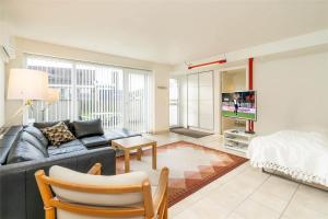 a living room with a couch and a bed at 770-Hvide-Sande-Norregade-4-B in Hvide Sande