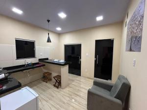 a office with a desk and a chair in a room at Loft Marajó Superior in Soure