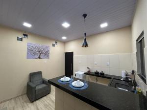 a kitchen with a sink and a chair at Loft Marajó Superior in Soure