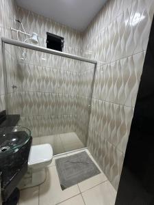 a bathroom with a toilet and a sink at Loft Marajó Superior in Soure +4 photos