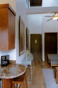 a living room with a counter and a table at Hacienda Martlot in Ensenada