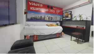 a small room with a bed and a chair at JaimeCrazyhostel in Huarmey