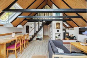 a loft conversion with a dining room and living room at 303-Hvide-Sande-Fyrmarken-36 in Hvide Sande