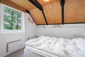 a white bed in a room with a window at 303-Hvide-Sande-Fyrmarken-36 in Hvide Sande