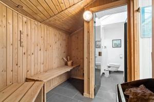 a wooden bathroom with a toilet and a bench at 6600-Hvide-Sande-Bjerregaardsvej-128 in Bjerregård +37 photos