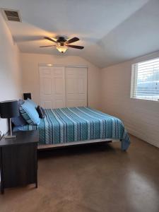 a bedroom with a bed and a ceiling fan at Quiet Desert Oasis off Swan Rd in Tucson