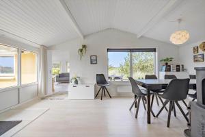 a dining room with a table and chairs at 621-Hvide-Sande-Dortheasvej-8 in Bjerregård