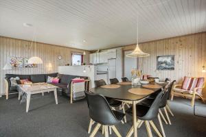 a living room with a dining table and a kitchen at 467-Hvide-Sande-Tingodden-212 in Hvide Sande