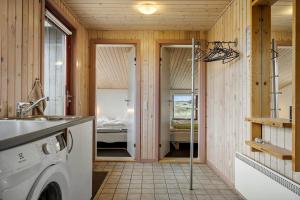 a bathroom with a washing machine in a room at 467-Hvide-Sande-Tingodden-212 in Hvide Sande +27 photos