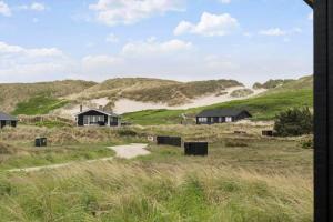 a view of houses in a field with hills at 467-Hvide-Sande-Tingodden-212 in Hvide Sande