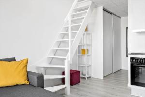 a white staircase in a living room with a couch at 774-Hvide-Sande-Norregade-2-nr-7 in Hvide Sande +22 photos