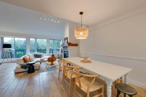 a kitchen and living room with a table and chairs at Unité 17 - Ski-in Ski-out in Beaupré