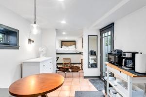 a kitchen with a table and a bed in a room at The Montlake Spite House in Seattle