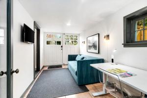a living room with a blue couch and a table at The Montlake Spite House in Seattle