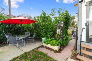 a patio with a table with a red umbrella at The Montlake Spite House in Seattle