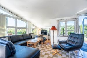 a living room with a couch and chairs and windows at 439-Hvide-Sande-Tingodden-120 in Hvide Sande