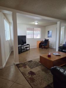 a living room with a couch and a tv at Quiet Desert Oasis off Swan Rd in Tucson