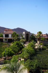 a view of a town with trees and a building at Hacienda Martlot in Ensenada