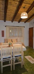 a bedroom with two beds and a chandelier at Tierra Norte - Cabañas in Tilcara