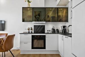 a kitchen with white cabinets and an oven at 777-Hvide-Sande-Norregade-2-nr-2 in Hvide Sande +22 photos