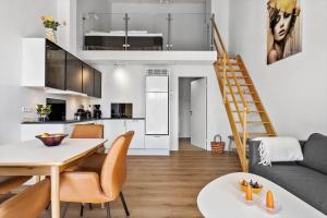 a kitchen and living room with a table and chairs at 777-Hvide-Sande-Norregade-2-nr-2 in Hvide Sande