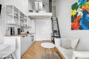 a living room with a white couch and a kitchen at 781-Hvide-Sande-Norregade-2-nr-9 in Hvide Sande