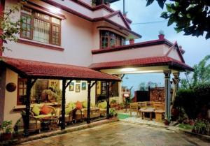 a large house with a pavilion in front of it at D Eco Resort in Dhulikhel +1 photo