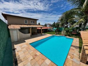 a swimming pool in front of a house at House Beach Canoa in Canoa Quebrada