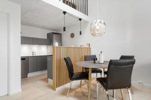 a kitchen and dining room with a table and chairs at 771-Hvide-Sande-Norregade-2-nr-28 in Hvide Sande