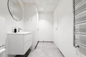 a white bathroom with a sink and a mirror at 771-Hvide-Sande-Norregade-2-nr-28 in Hvide Sande +19 photos