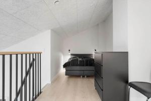 a bedroom with a bed in a white room at 771-Hvide-Sande-Norregade-2-nr-28 in Hvide Sande