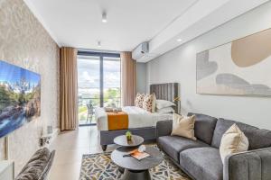 a living room with a couch and a bed at Serene Spaces, Ellipse in Midrand