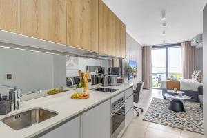 a kitchen with a sink and a counter top at Serene Spaces, Ellipse in Midrand