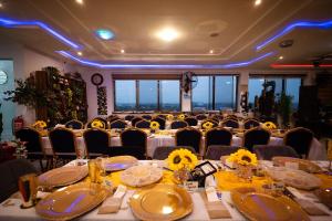 a dining room with a long table with yellow flowers on it at Cherry Signature Condos in Adentan +74 photos