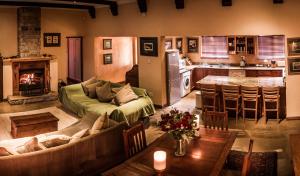 a living room with a couch and a kitchen at The FarSide Dam Cottage in Nottingham Road