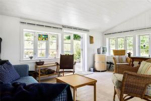 a living room with couches and a table and windows at 1035-Stege-Teglvaerksvej-39 in Stege