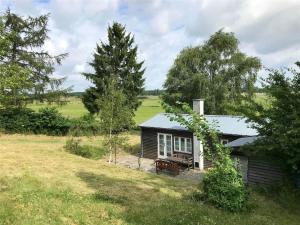 a small house with a picnic table in a field at 1035-Stege-Teglvaerksvej-39 in Stege