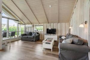 a living room with two couches and a tv at FA066-Faxe-Ladeplads-Engsvinget-5 in Fakse Ladeplads